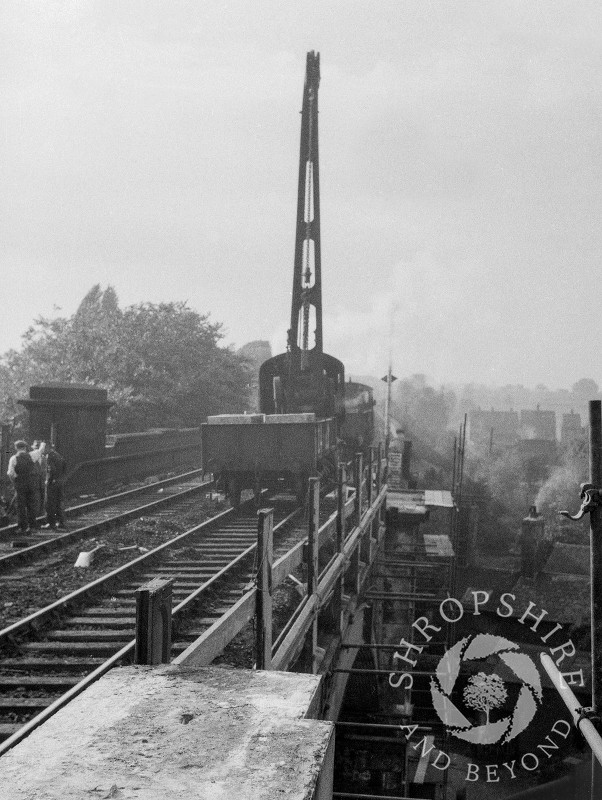 A crane dismantling the old railway bridge, Shifnal, Shropshire, 1953.