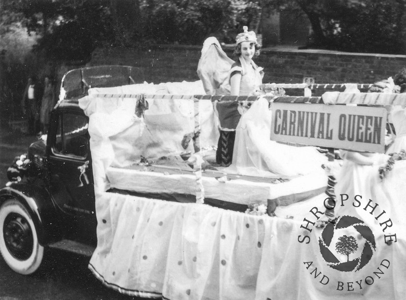 Carnival Queen float in Church Street, Shifnal, Shropshire, during the annual carnival, 1950s.