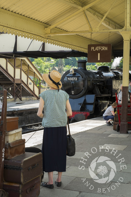 A passenger waiting on the platform at Llangollen Railway Station, Wales.