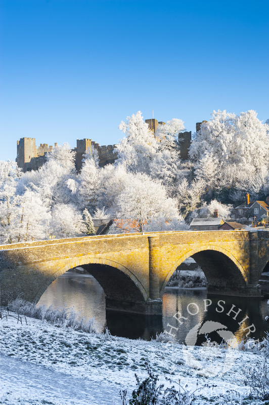 Dinham Bridge and Ludlow Castle under a layer of hoar frost at Ludlow, Shropshire, England.