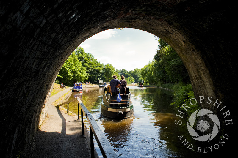 A canal boat leaving Darkie Tunnel at Chirk, Wrexham, Wales.