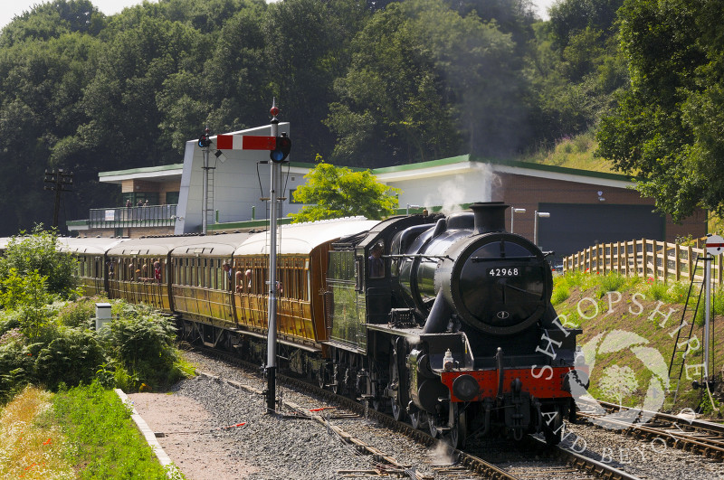An LMR Stanier steam locomotive enters Highley Station past the Engine House, Severn Valley Railway, Shropshire, England.