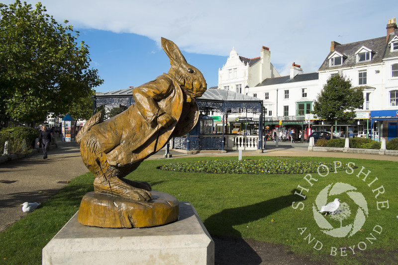 The White Rabbit wooden statue  celebrates the town's links to Alice In Wonderland author Lewis Carroll, Llandudno, Wales. 