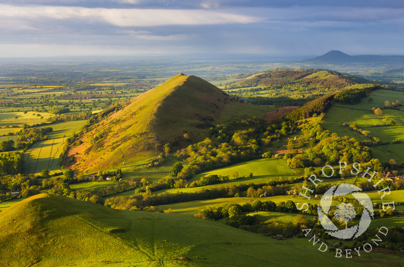 Evening light on Caer Caradoc and the Lawley, Shropshire, with the Wrekin in the distance.