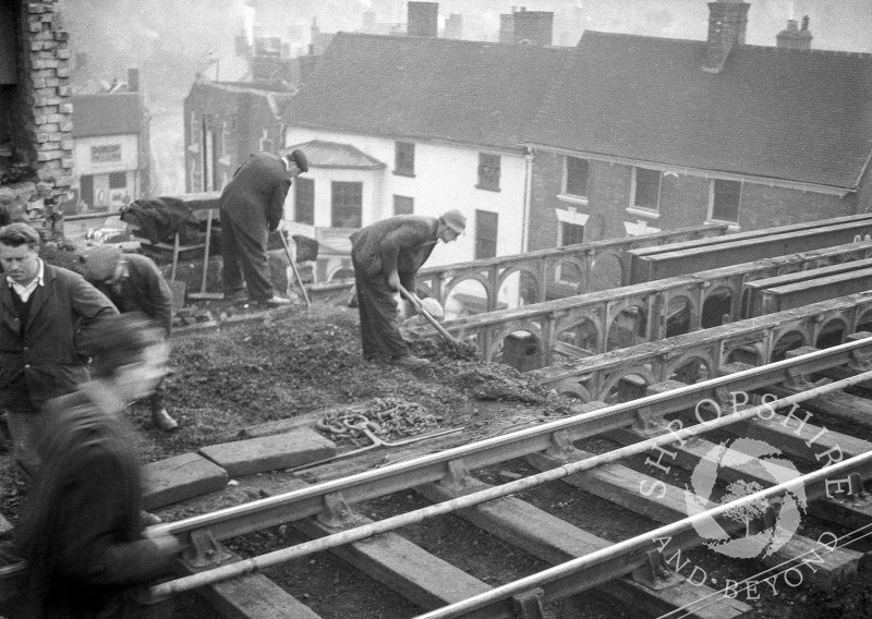 Workmen on the old railway bridge at Shifnal, Shropshire, 1953.