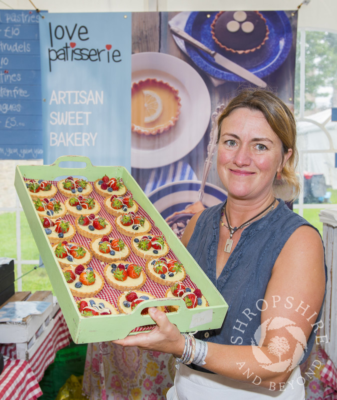 Tracey Dugan of Love Patisserie with a tray of bakes at the 2016 Ludlow Food Festival, Shropshire.