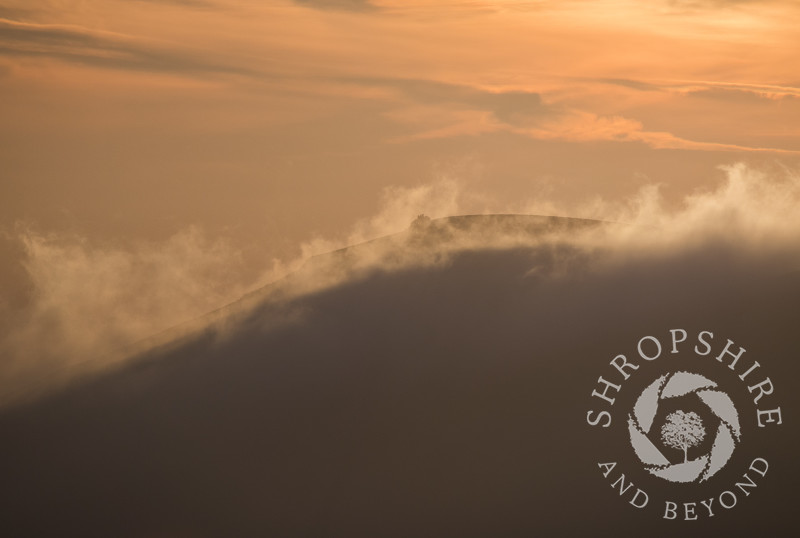 Mist rolls over Wilstone Hill, seen from the Long Mynd, Shropshire.