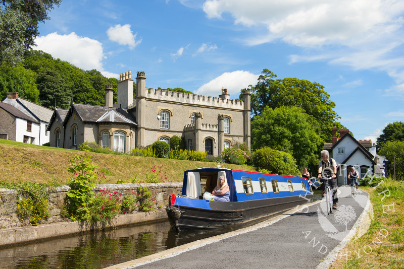 Cyclists on the towpath alongside the canal wharf in Llangollen, Denbighshire, Wales.