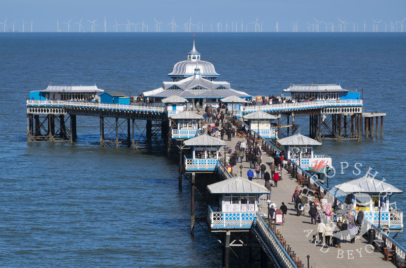 A busy day on Llandudno Pier, North Wales, looking towards the  offshore wind farm.