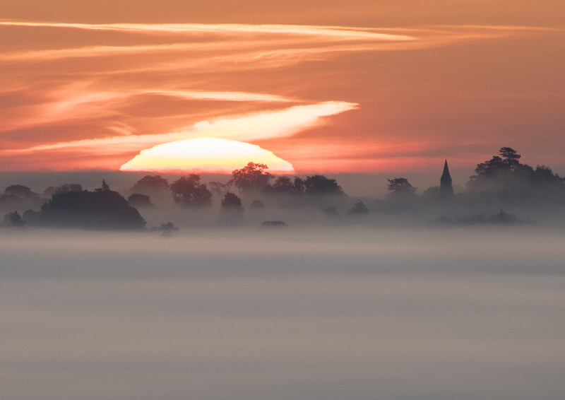 Sunrise near Welsh Frankton Church, seen from Old Oswestry Hill Fort.