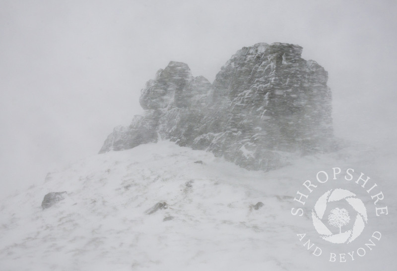 Three Fingers Rock during a blizzard on Caer Caradoc, Shropshire.