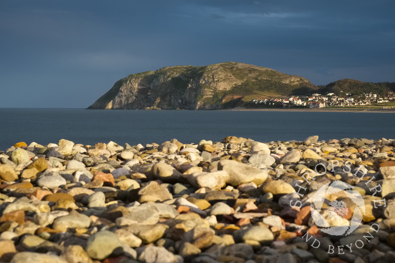 Autumn sunlight on the beach and Little Orme at Llandudno, Conwy, Wales.