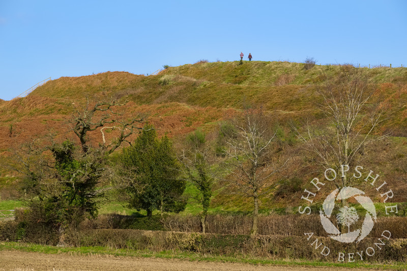 Walkers on the ramparts of Old Oswestry Hill Fort, north Shropshire.