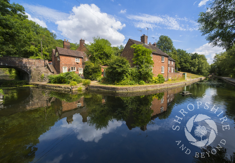 Cottages reflected in the Shropshire Canal at Coalport, Shropshire, England.