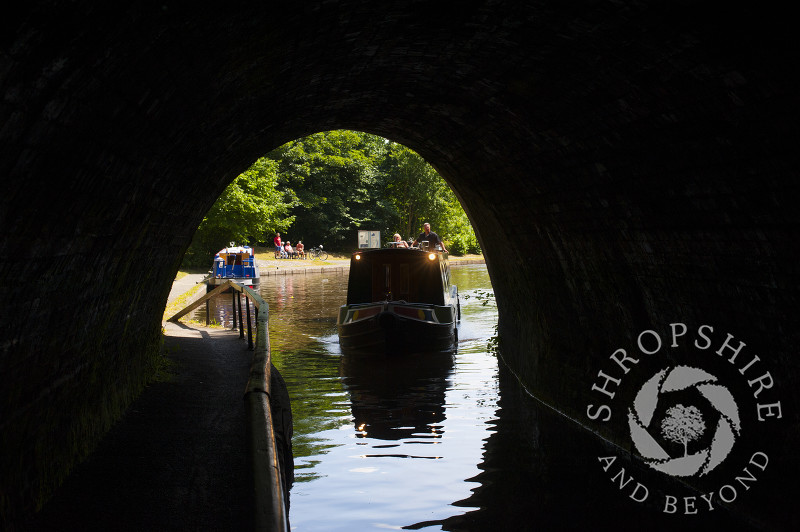 A canal boat enters Darkie Tunnel at Chirk, Wrexham, Wales.