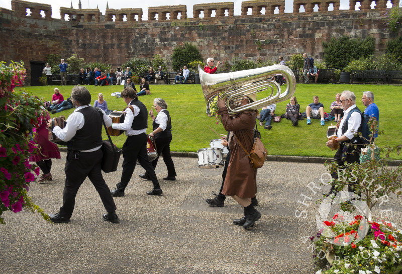 A marching band of Morris dance musicians in Shrewsbury Castle during Shrewsbury Folk Festival, Shropshire, England.
