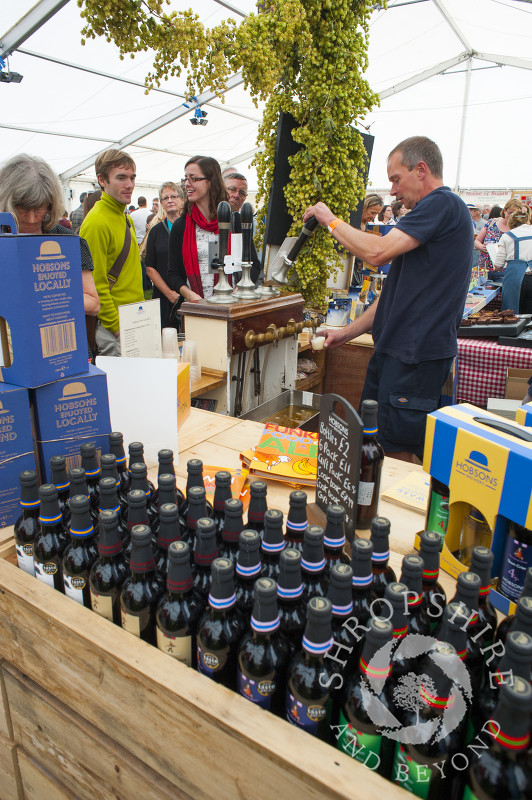 A vendor pulls a pint of beer at Ludlow Food Festival, Shropshire, England.