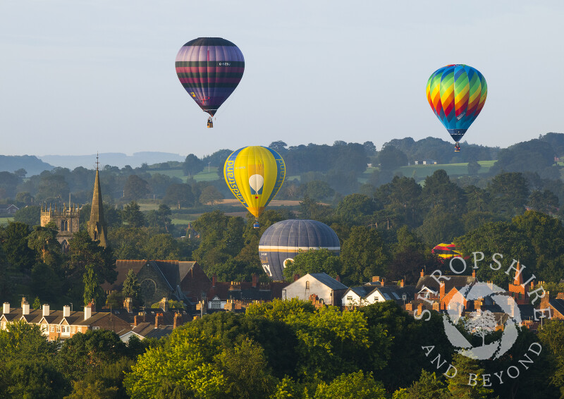 Hot air balloons lift off during the annual Oswestry Balloon Carnival, seen from Old Oswestry Hill Fort, Shropshire.