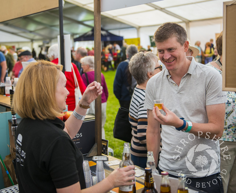 A visitor samples Oldfields cider at Ludlow Food Festival, Shropshire.
