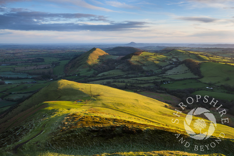 Winter sunrise on Caer Caradoc and the Lawley, Stretton Hills, Shropshire. The Wrekin can be seen in the far distance.