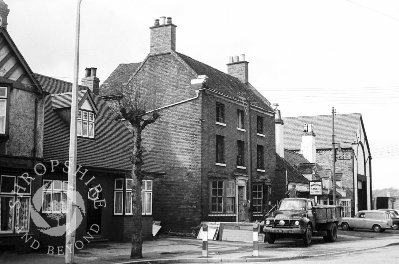 A house in the process of being demolished next to the Wheatsheaf public house in Broadway, Shifnal, Shropshire, in 1966.