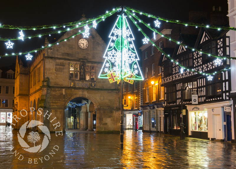 Christmas lights reflected in rain-covered flagstones in the Square, Shrewsbury, Shropshire.