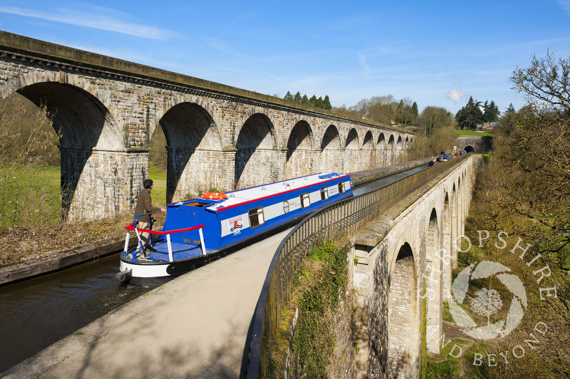 A canal boat crossing Chirk Aqueduct on the Llangollen Canal, on the English/Welsh border.