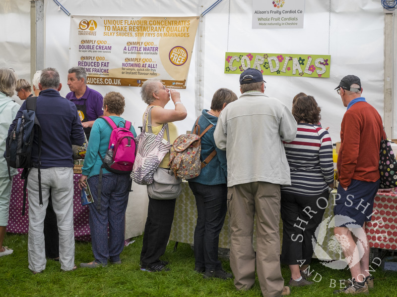 Visitors sample sauces and cordials at Ludlow Food Festival, Shropshire.
