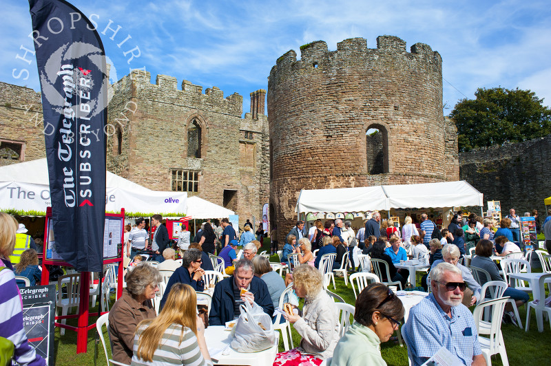 Visitors enjoy the sunshine in the grounds of Ludlow Castle during Ludlow Food Festival, Shropshire, England.