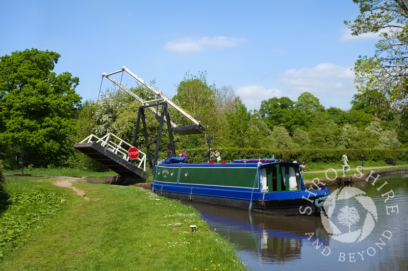A narrowboat negotiates a lift bridge on the Llangollen Canal at Whitchurch, Shropshire.