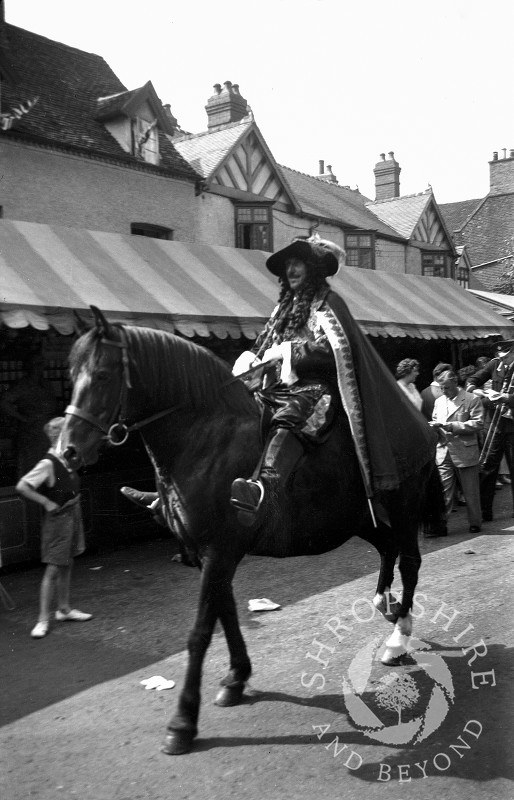 A character on horseback at the annual carnival parade in Shifnal, Shropshire, during the 1950s.