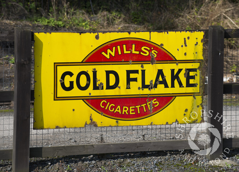 Vintage enamel sign advertising Wills's Gold Flake Cigarettes at Highley Station, Shropshire, on the Severn Valley Railway heritage line.