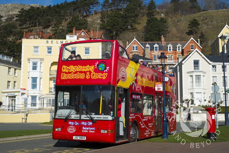A sightseeing bus on the seafront in Llandudno, North Wales.