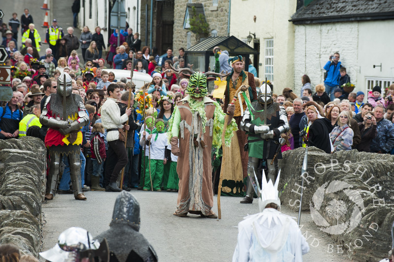 The Green Man confronts the Frost Queen on the bridge during the Clun Green Man Festival in Shropshire.