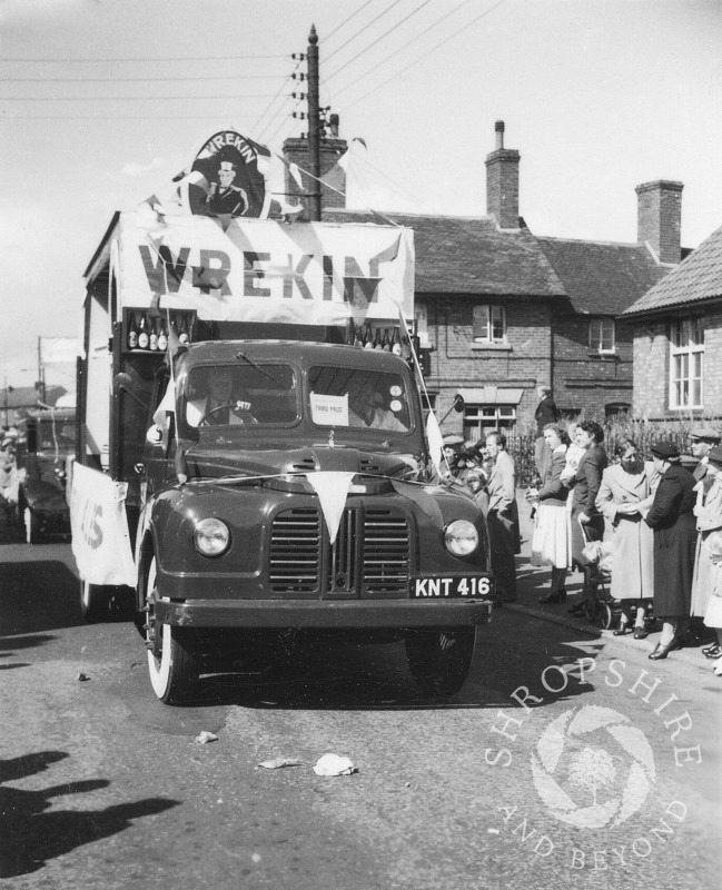 The Wrekin Brewery float passes the Beehive public house in Shifnal, Shropshire, during the town's annual carnival in the 1950s.