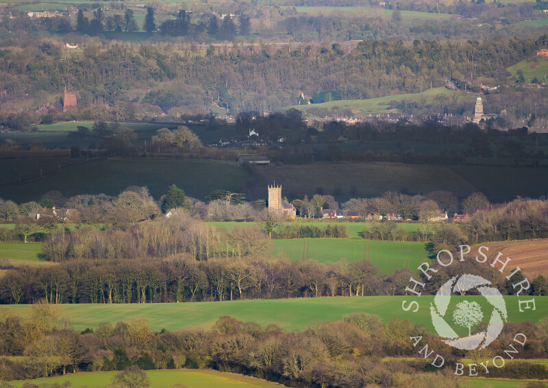 The view from Brown Clee, Shropshire, with St Giles' Church at Chetton in the foreground. In the distance are St Leonard's Church and St Mary's Church at Bridgnorth.