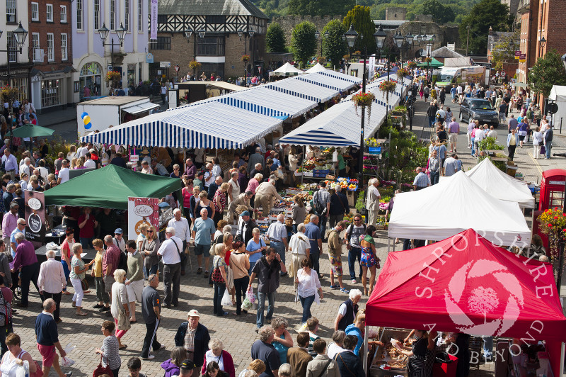Shoppers and stalls fill the Castle Square during Ludlow Food Festival, Shropshire, England.