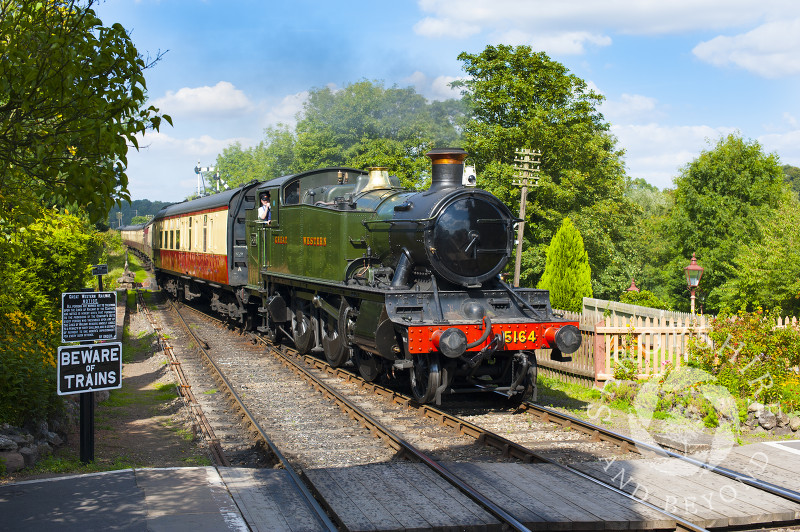 A GWR 5164 Large Prairie steam locomotive pulls into Hampton Loade Station, Severn Valley Railway, Shropshire, England.