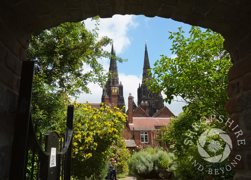 A view of Lichfield Cathedral seen through a gateway at Erasmus Darwin House in Lichfield, Staffordshire, England.