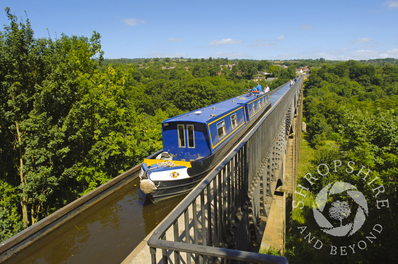 A narrowboat passes along the Llangollen Canal on the Pontcysyllte Aqueduct, North East Wales.