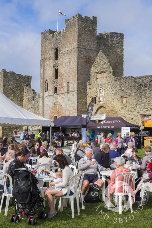 Visitors enjoy the sunshine in the grounds of Ludlow Castle, during Ludlow Food Festival, Shropshire.