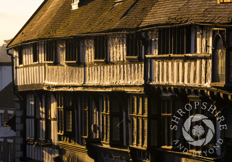 Sunrise illuminates half-timbered buildings on Wyle Cop, Shrewsbury, Shropshire.