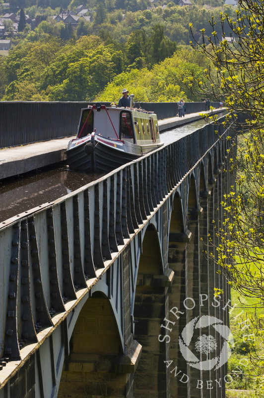 A narrowboat passes along the Llangollen Canal on the Pontcysyllte Aqueduct, North East Wales.