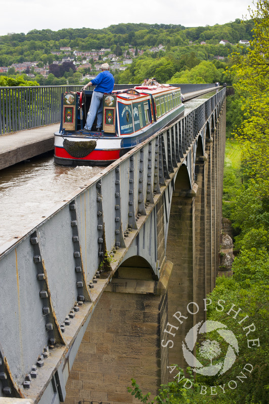 A narrowboat passes along the Llangollen Canal on the Pontcysyllte Aqueduct, North East Wales.