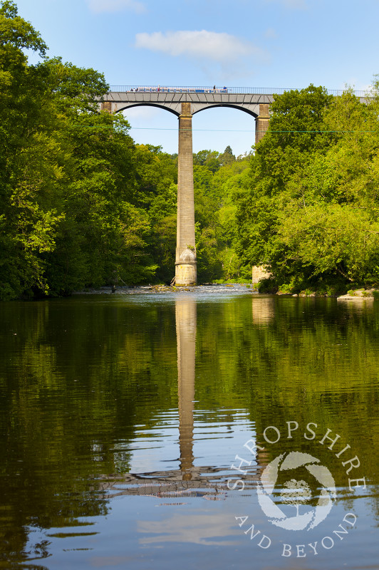 A canal boat pasing along Pontcysyllte Aqueduct, above the River Dee, Wales.