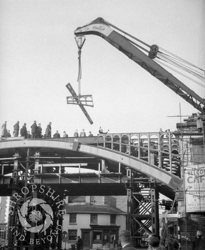 A crane lifting parts of the old railway bridge, Shifnal, Shropshire, 1953.