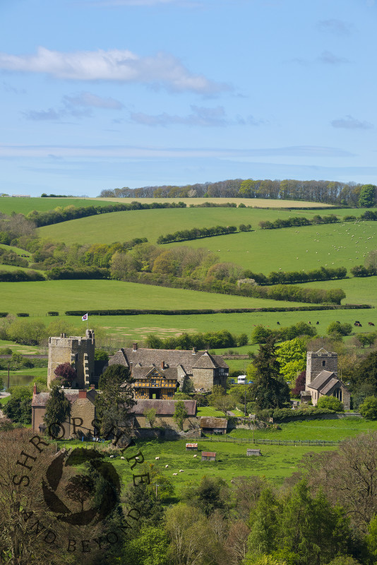 Stokesay Castle and the church of St John the Baptist, near Craven Arms, Shropshire, seen from Nortoncamp Wood.