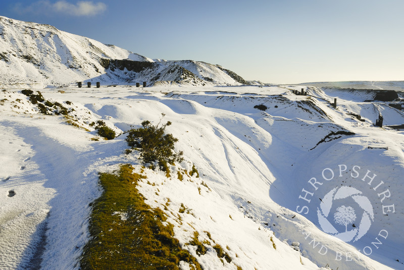 Sunlight on winter snow covering Titterstone Clee Hill, Shropshire, England.