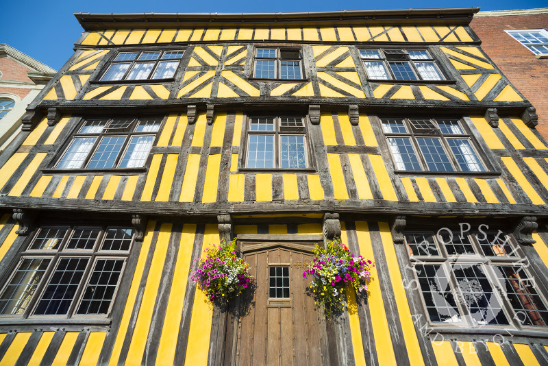 Hanging baskets outside a half-timbered house in Broad Street, Ludlow, Shropshire, England.