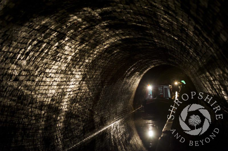 A narrowboat passing through Darkie Tunnel towards Chirk Aqueduct, Wrexham, Wales.